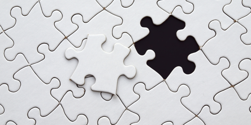 White jigsaw puzzle pieces with one missing